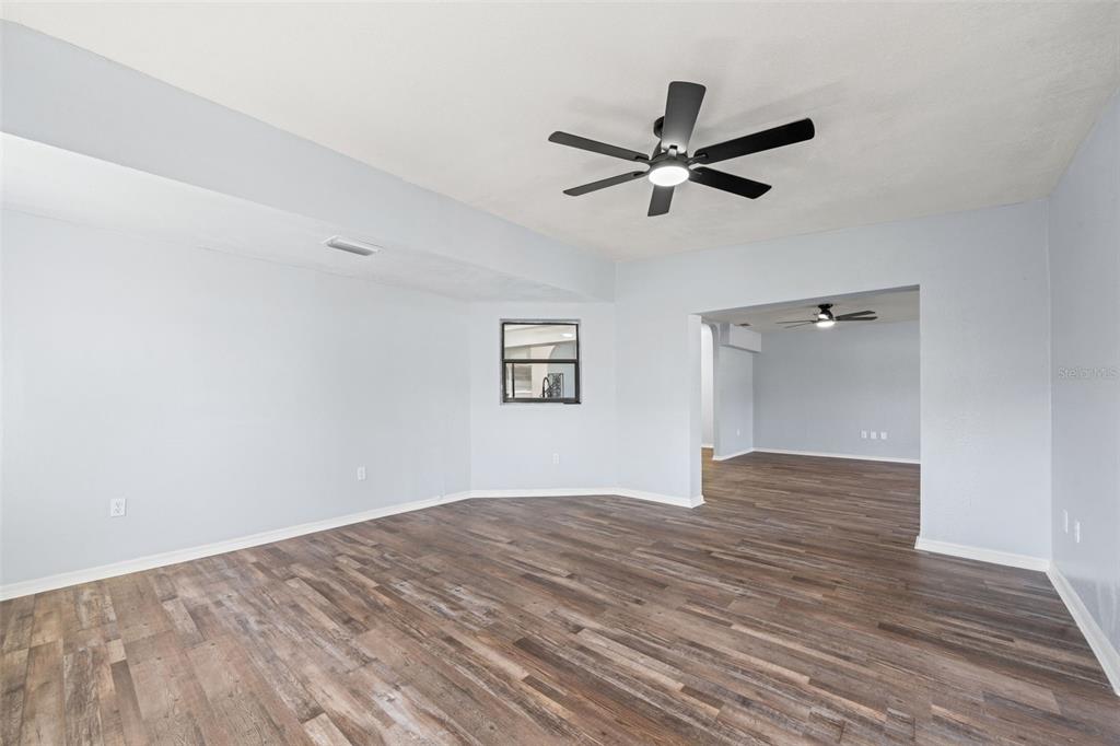 11215 Addison Street Spring Hill, FL 34609 - Photo 32 of 51 a view of empty room with wooden floor