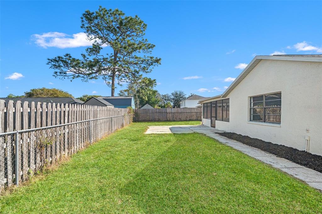 11215 Addison Street Spring Hill, FL 34609 - Photo 40 of 51 a view of a house with backyard and tree