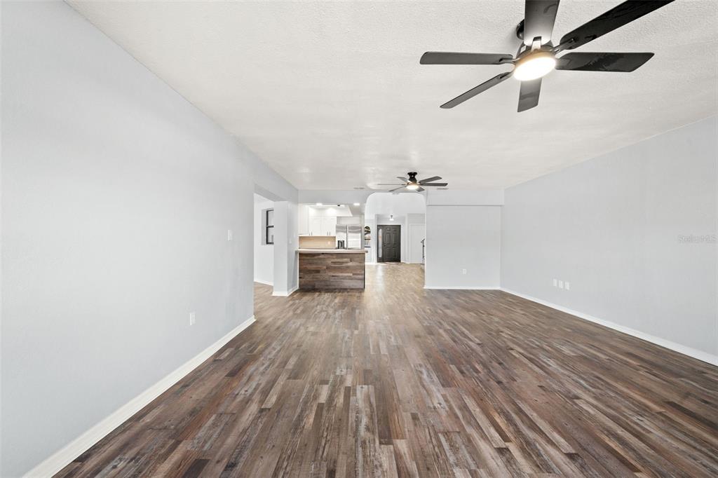11215 Addison Street Spring Hill, FL 34609 - Photo 10 of 51 a view of empty room with wooden floor
