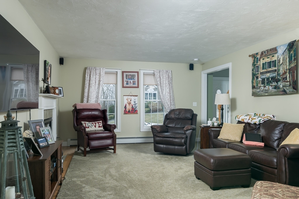 34 Marjorie Lane Rutland, MA 01543 - Photo 9 of 33 a living room with furniture a flat screen tv and a fireplace