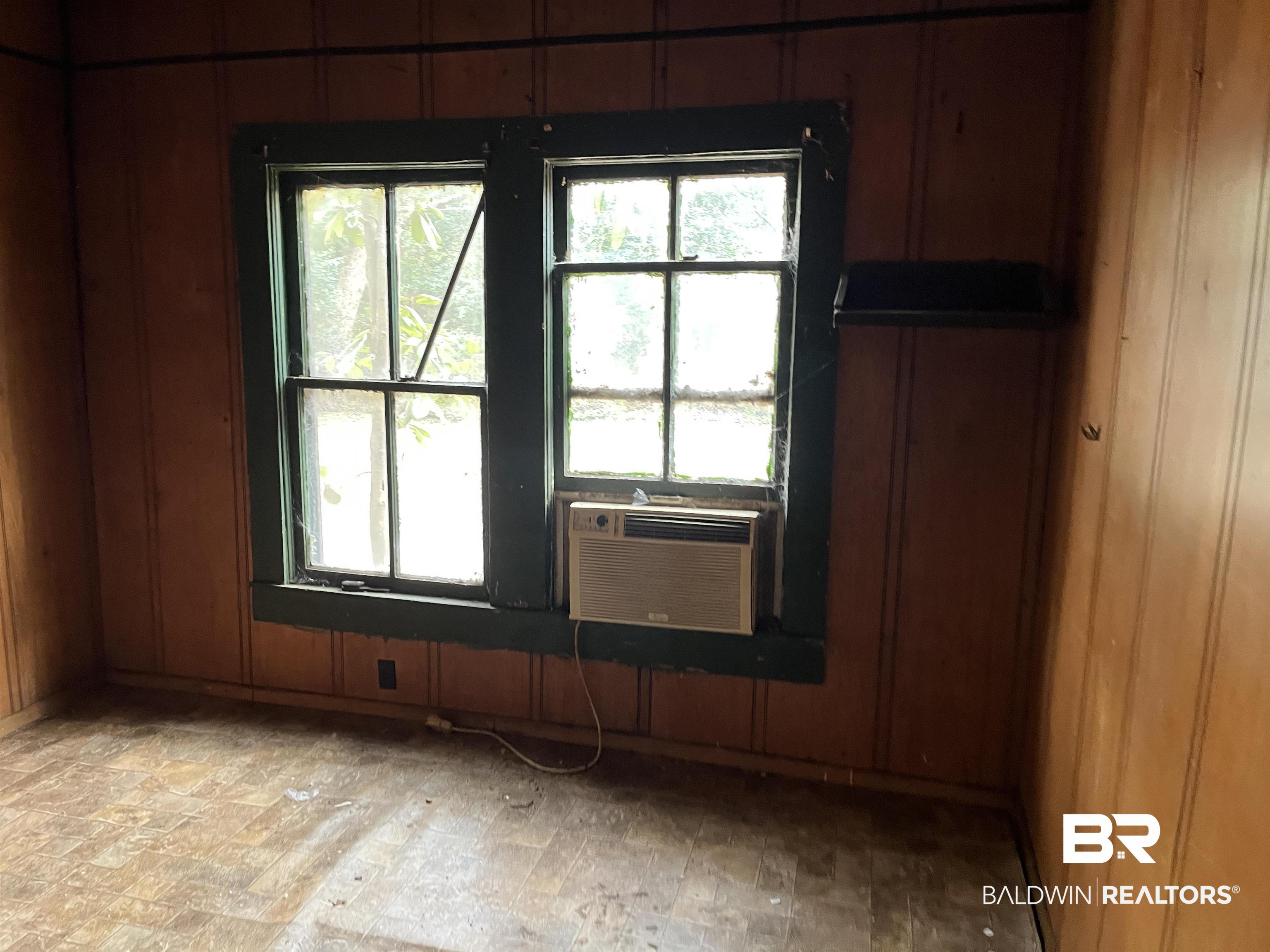 139 Rutherford Street Monroeville, AL 36460 - Photo 5 of 6 Unfurnished room with plenty of natural light and wood walls