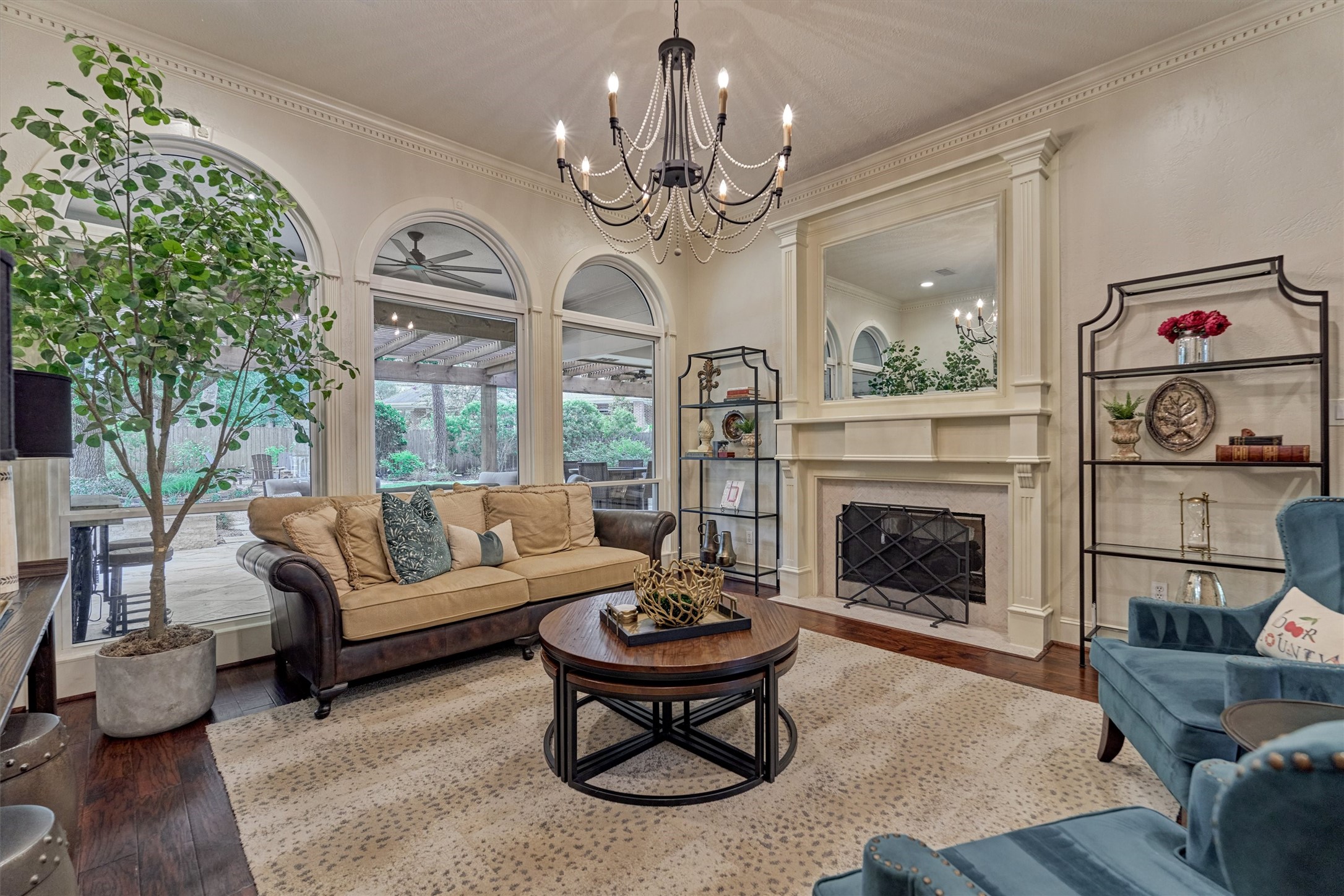 18 Treevine Court The Woodlands, TX 77381 - Photo 9 of 50 This formal living room exudes refinement with a fireplace, chandelier, and picturesque views of the outdoor living area.
