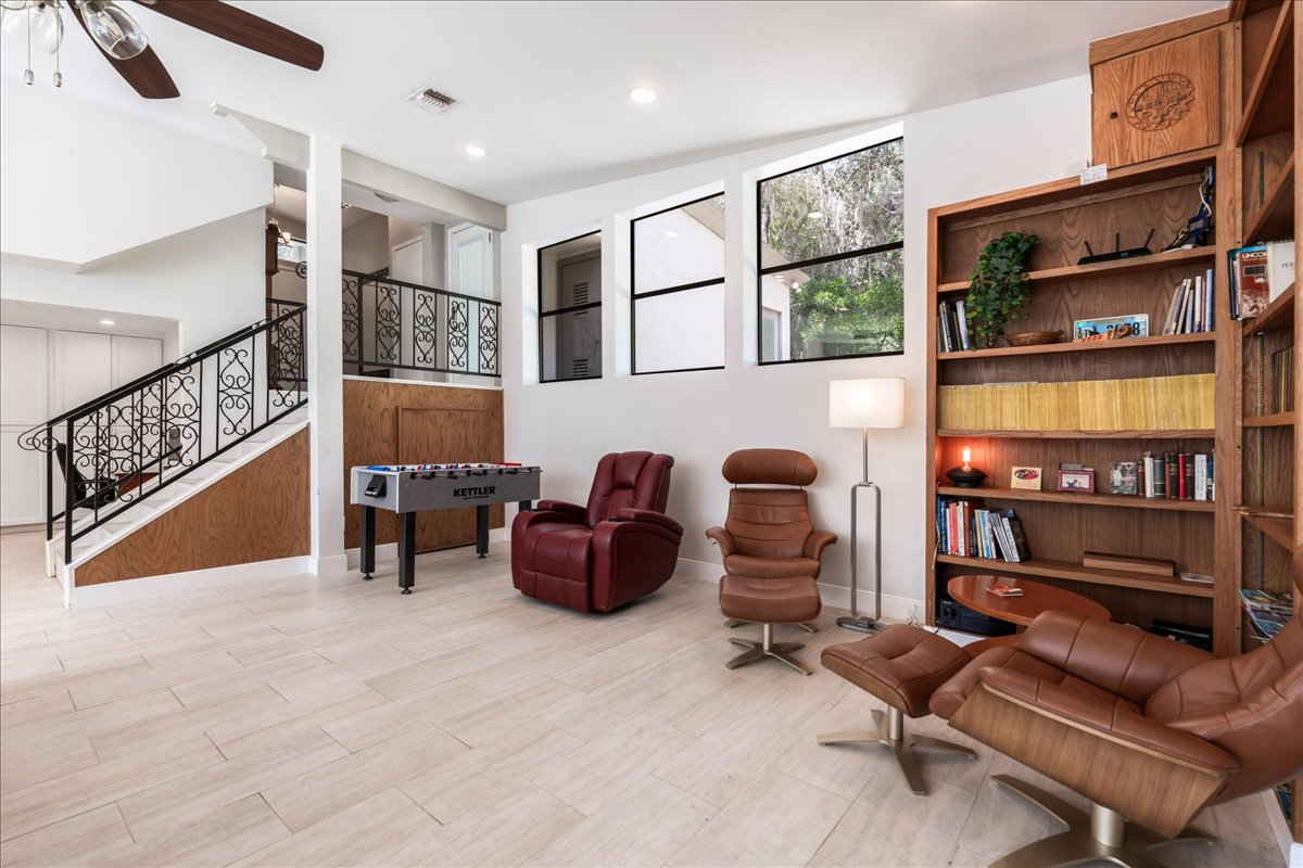 207 Rogers Ridge Street San Marcos, TX 78666 - Photo 12 of 35 A richly color-drenched office offers a sophisticated retreat, featuring beautifully crafted built-in bookshelves and abundant natural light that highlights the room’s character & refined atmosphere.