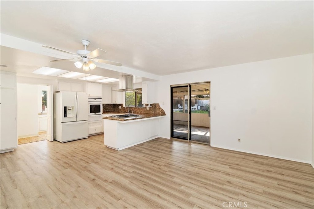 1330 La Serena Drive Glendora, CA 91740 - Photo 13 of 36 a large white kitchen with a refrigerator a stove top oven a chimney and a counter space