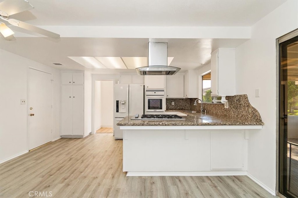 1330 La Serena Drive Glendora, CA 91740 - Photo 14 of 36 a kitchen with kitchen island stainless steel appliances a sink and cabinets