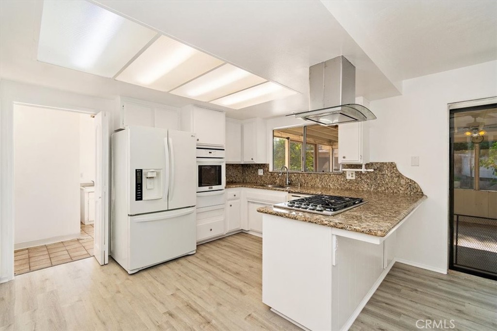 1330 La Serena Drive Glendora, CA 91740 - Photo 15 of 36 a kitchen with white cabinets and appliances