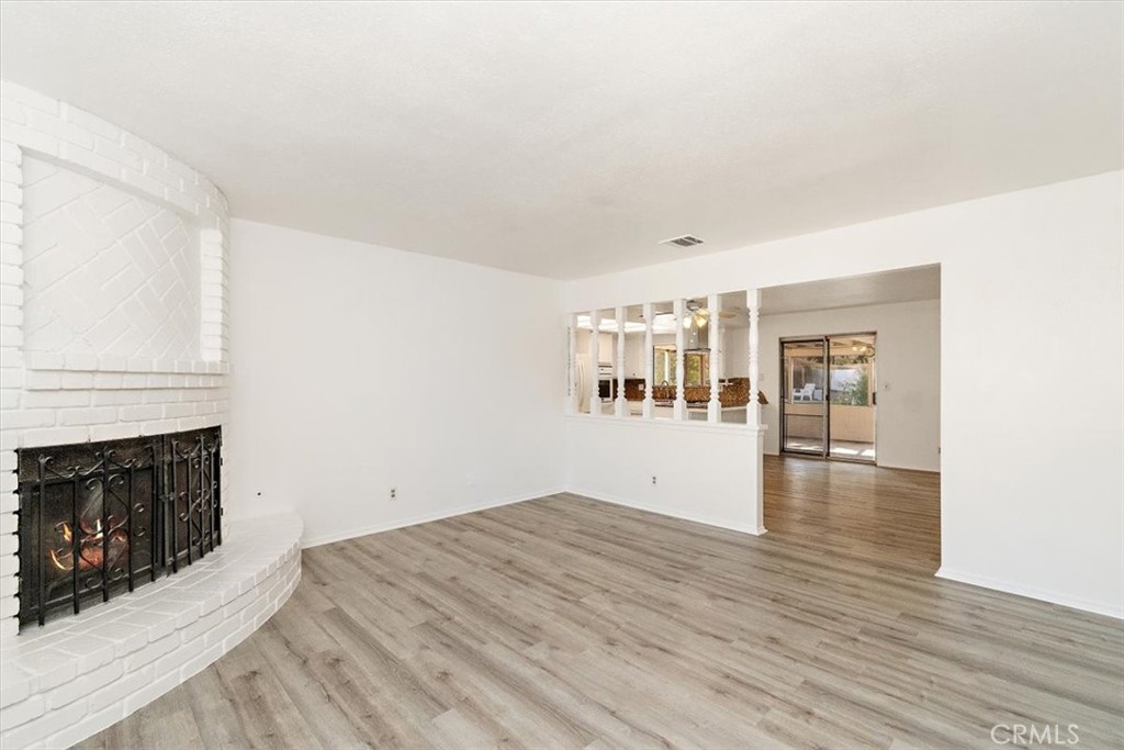 1330 La Serena Drive Glendora, CA 91740 - Photo 3 of 36 a view of empty room with wooden floor and fireplace
