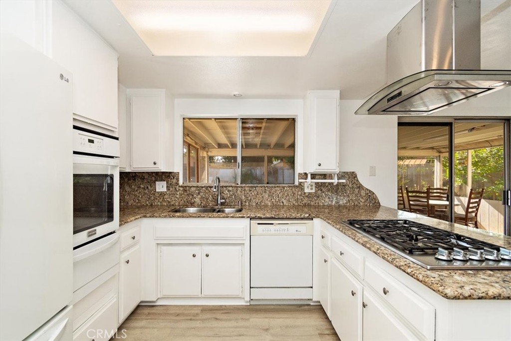 1330 La Serena Drive Glendora, CA 91740 - Photo 4 of 36 a kitchen with white cabinets and appliances