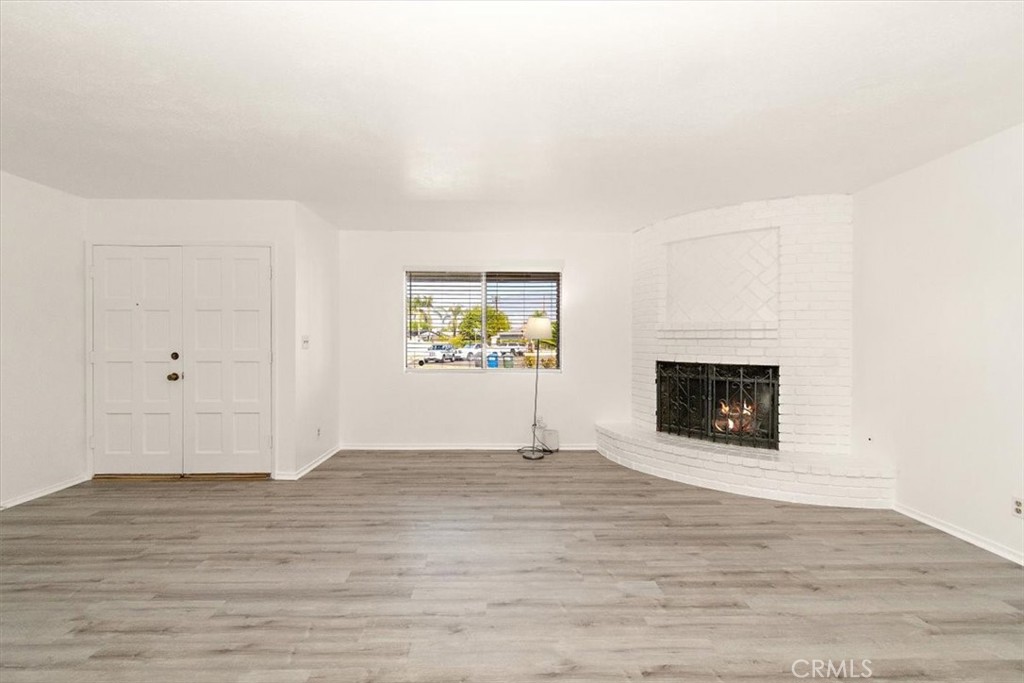 1330 La Serena Drive Glendora, CA 91740 - Photo 9 of 36 a view of an empty room with wooden floor and a fireplace