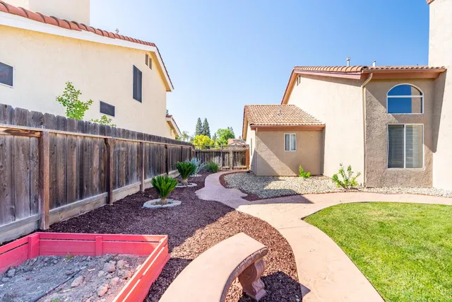 a view of a house with backyard and sitting area