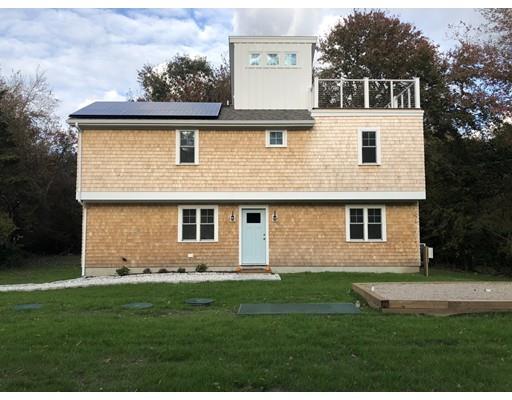 a front view of a house with a garden and yard