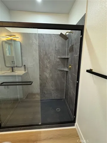 a bathroom with a glass shower door