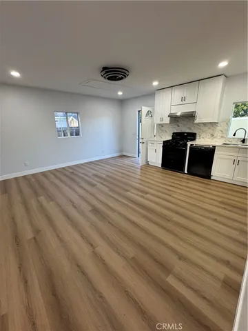 a large kitchen with kitchen island a sink stainless steel appliances and cabinets