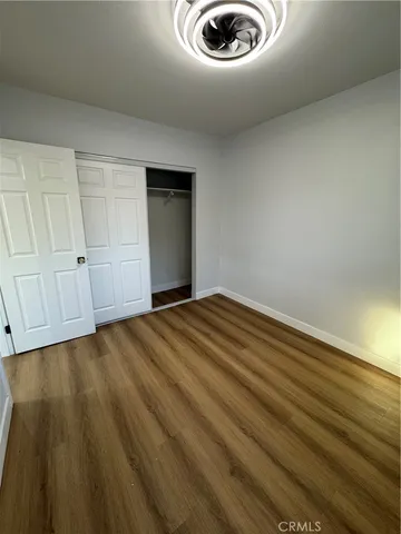 a view of an empty room and wooden floor