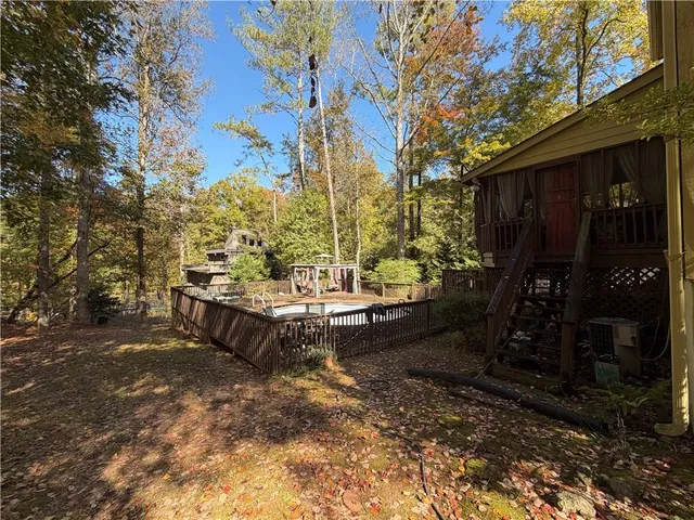 a backyard of a house with barbeque oven table and chairs
