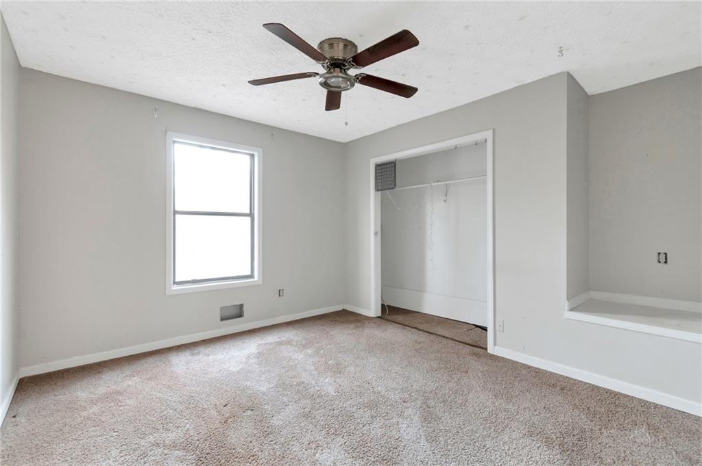 3523 Liberty Ridge Trail Marietta, GA 30062 - Photo 21 of 25 an empty room with ceiling fan and window
