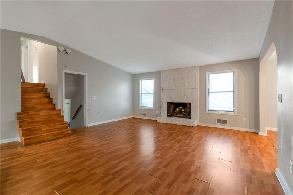 3523 Liberty Ridge Trail Marietta, GA 30062 - Photo 6 of 25 an empty room with wooden floor and fireplace