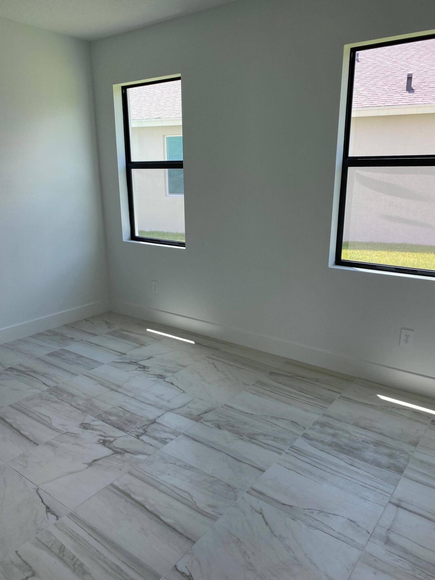 6810 Southeast Park Trace Drive Stuart, FL 34997 - Photo 12 of 21 an empty room with windows and cabinet