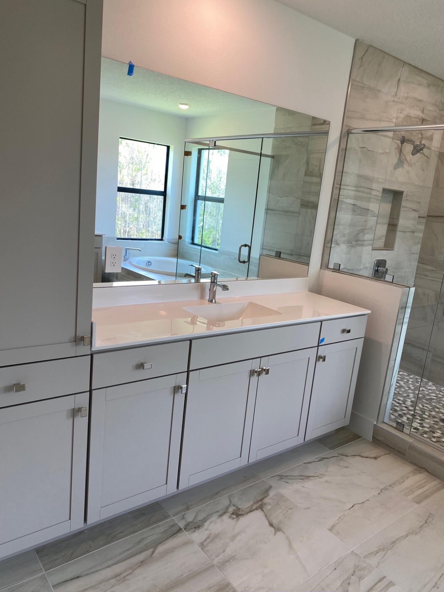 6810 Southeast Park Trace Drive Stuart, FL 34997 - Photo 16 of 21 a bathroom with a sink and a mirror