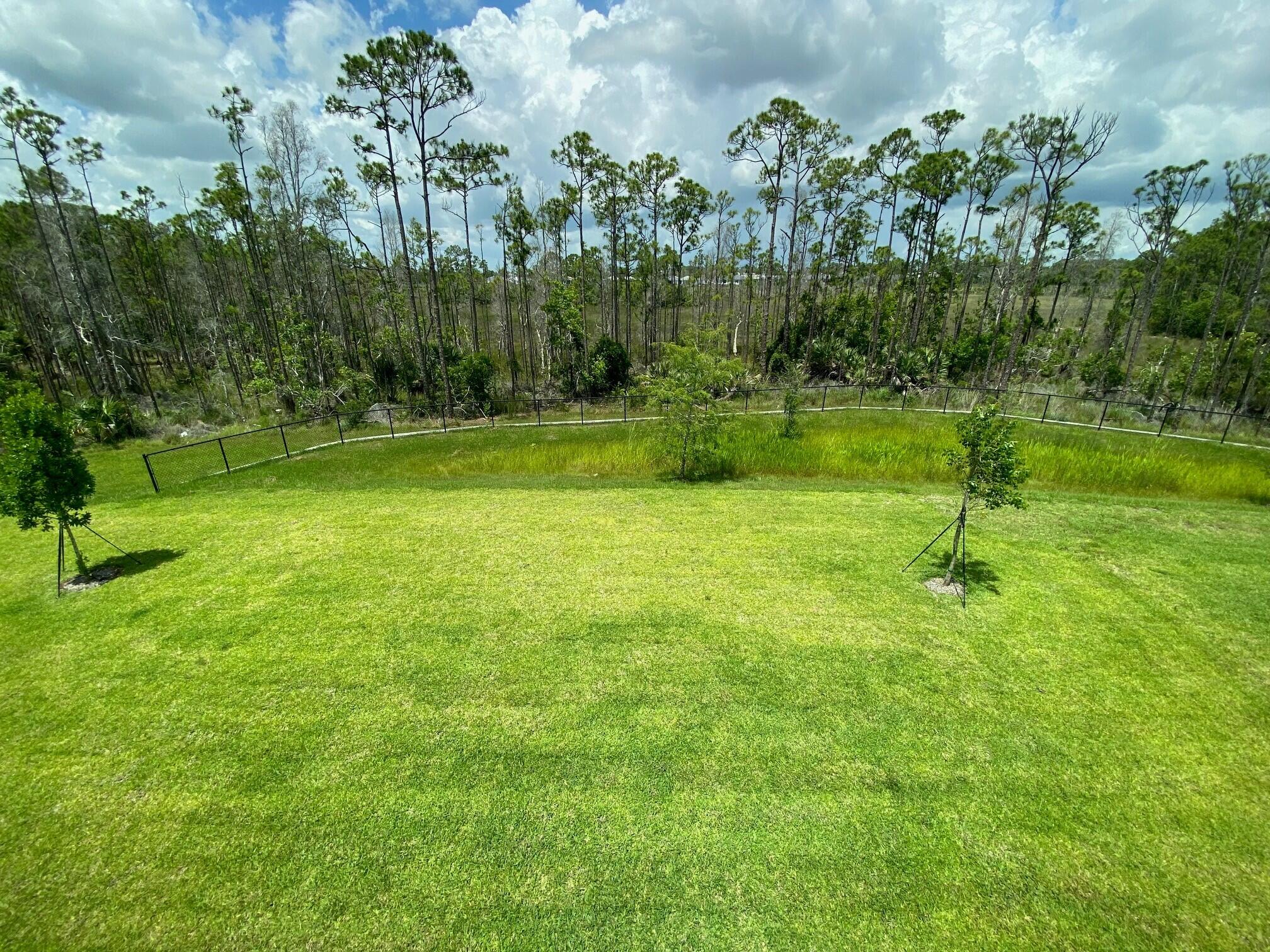 6810 Southeast Park Trace Drive Stuart, FL 34997 - Photo 21 of 21 a backyard of a house with lots of green space