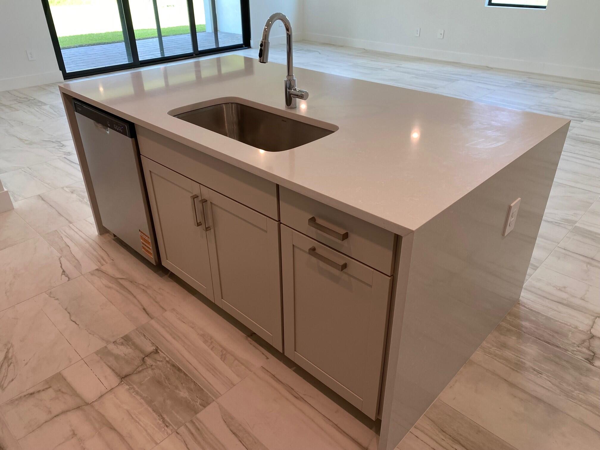 6810 Southeast Park Trace Drive Stuart, FL 34997 - Photo 6 of 21 a close view of sink and tap