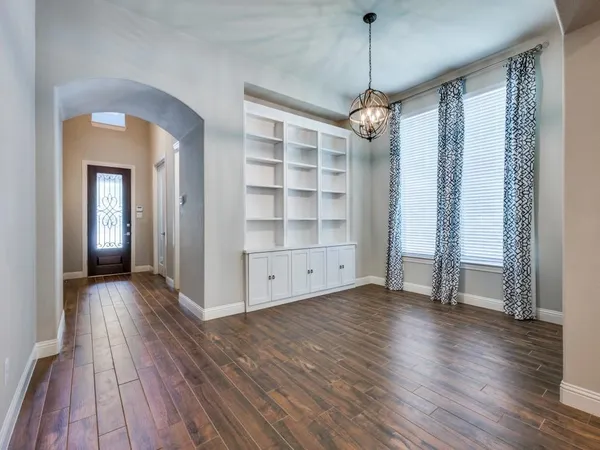 a view of a room with wooden floor staircase and windows