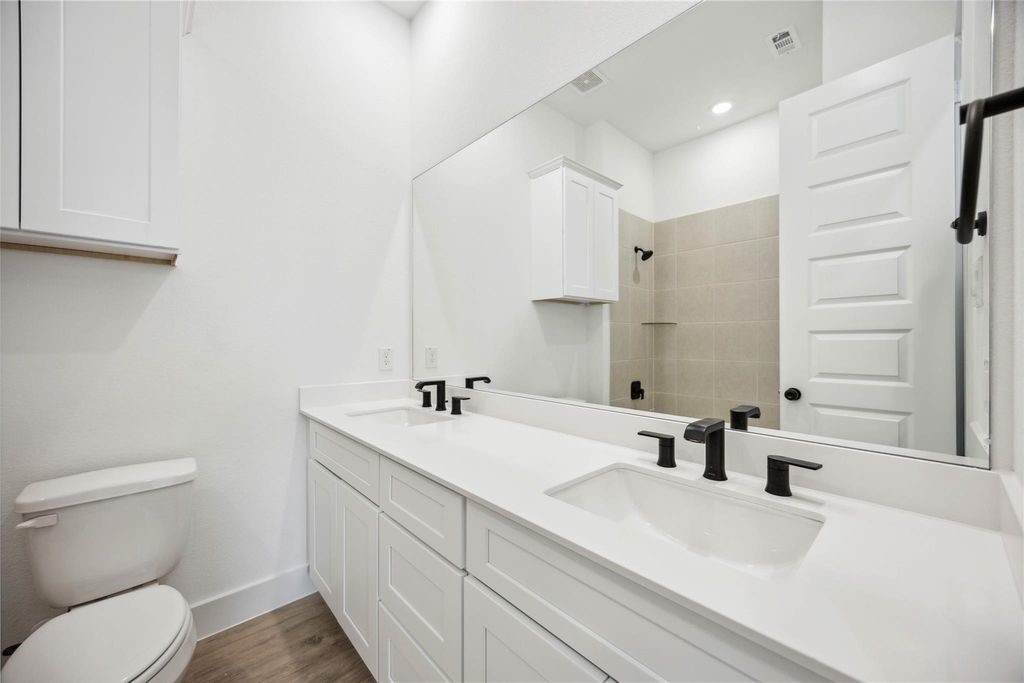 8103 Calhoun Road Houston, TX 77051 - Photo 15 of 29 a bathroom with a sink a toilet and mirror