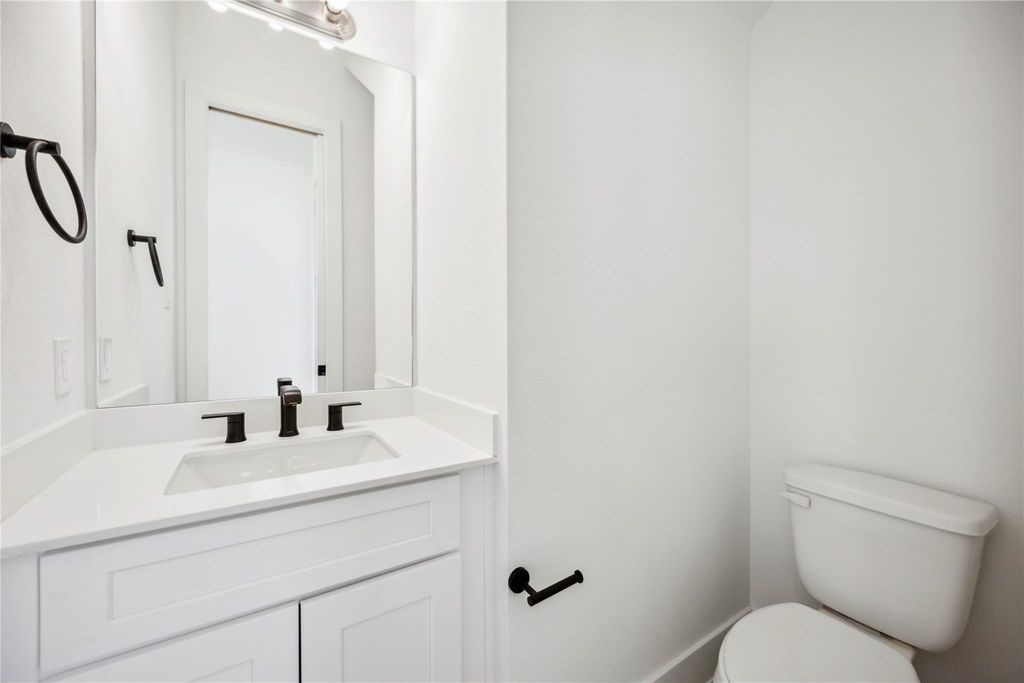 8103 Calhoun Road Houston, TX 77051 - Photo 23 of 29 a bathroom with a toilet sink and mirror