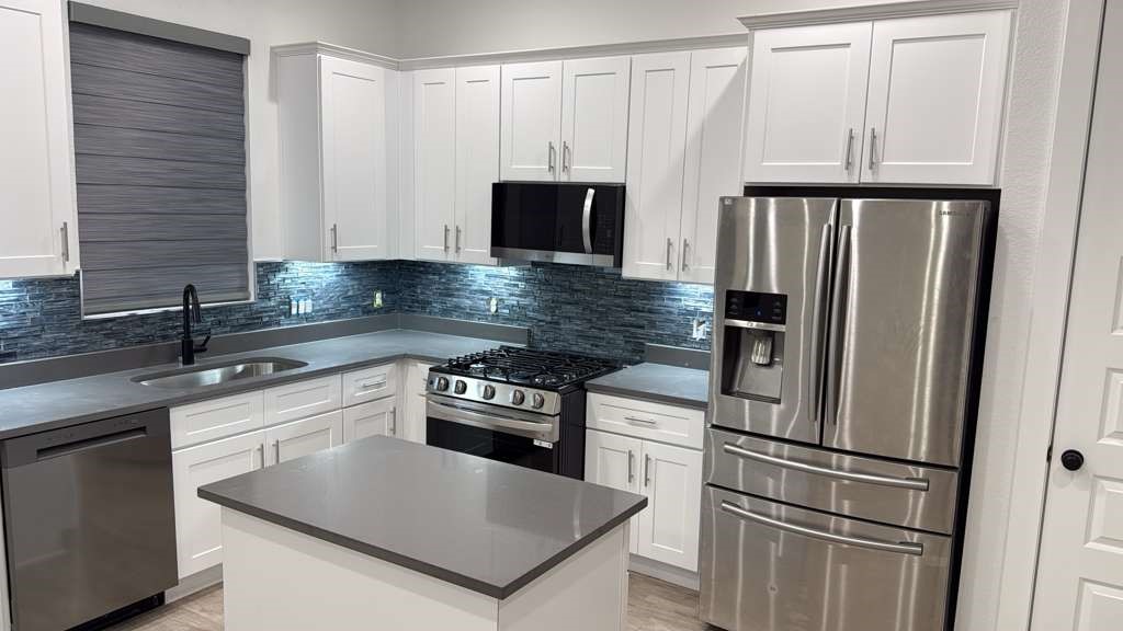 8103 Calhoun Road Houston, TX 77051 - Photo 27 of 29 a kitchen with granite countertop a refrigerator sink and stove