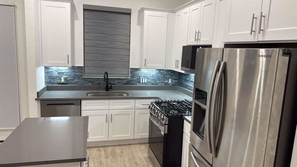 8103 Calhoun Road Houston, TX 77051 - Photo 29 of 29 a kitchen with appliances a sink and cabinets