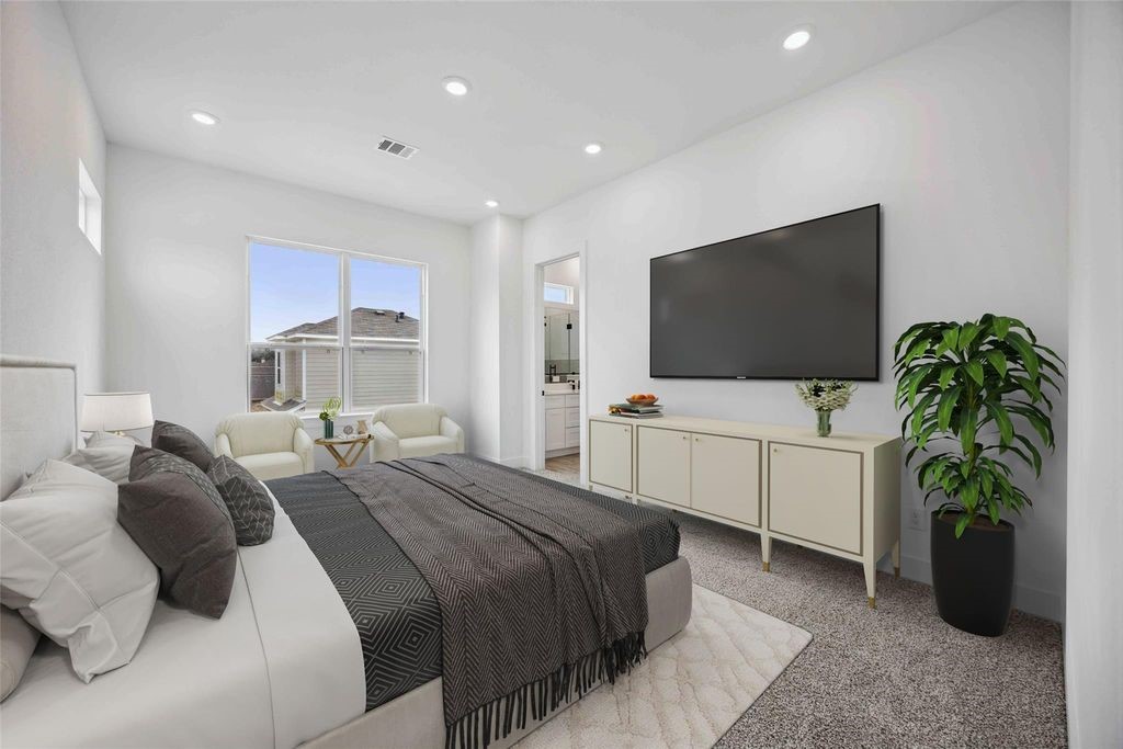 8103 Calhoun Road Houston, TX 77051 - Photo 3 of 29 a bedroom with a bed and a flat screen tv