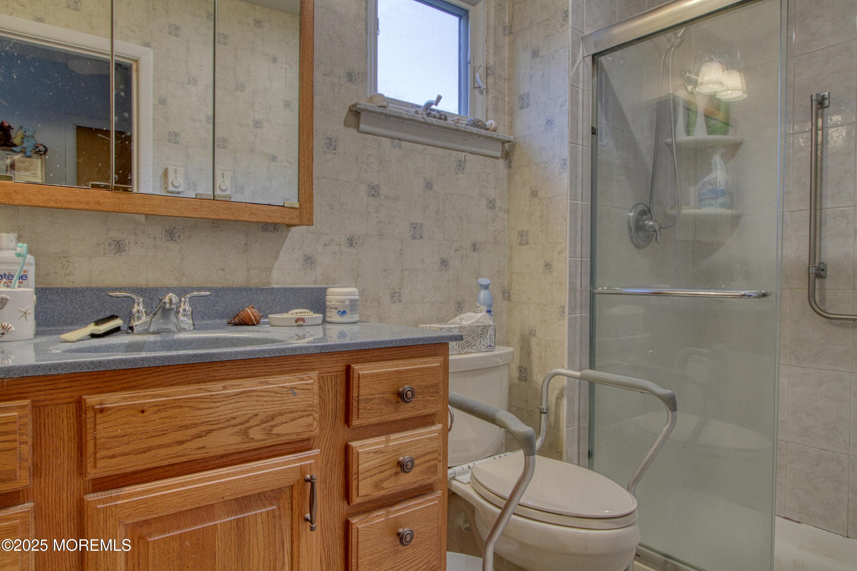 9 Greenleaf Street Whiting, NJ 08759 - Photo 9 of 16 a bathroom with a granite countertop toilet sink and shower