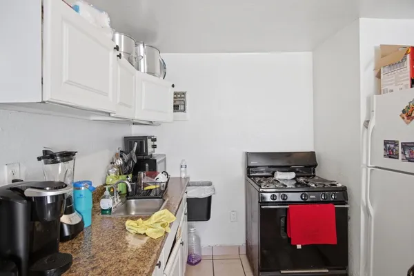a kitchen with stainless steel appliances granite countertop a stove and cabinets