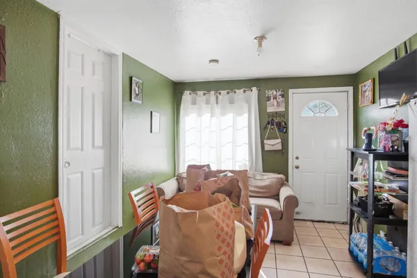 a living room with furniture a flat screen tv and a window