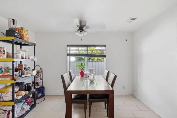 a view of a dining room with furniture and a window