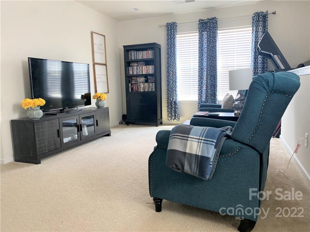 239 Elrosa Road Mooresville, NC 28115 - Photo 12 of 25 a living room with furniture and a flat screen tv