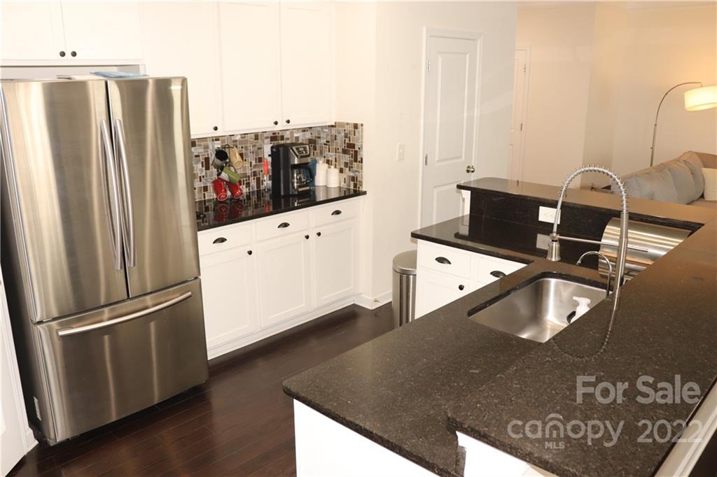 239 Elrosa Road Mooresville, NC 28115 - Photo 7 of 25 a kitchen with stainless steel appliances granite countertop a refrigerator and a stove