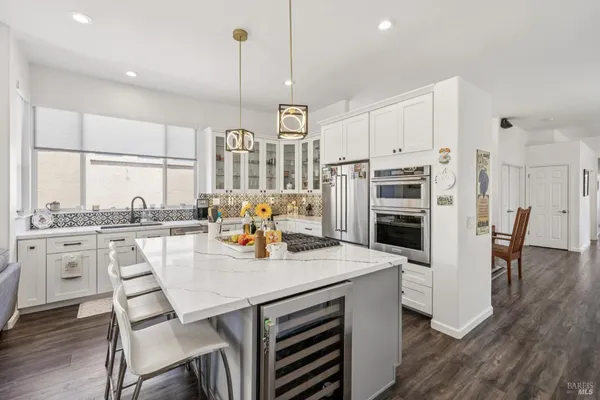 a view of kitchen with sink dining table and chairs