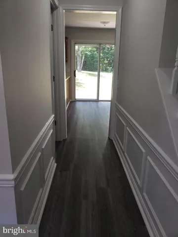 a view of hallway with wooden floor