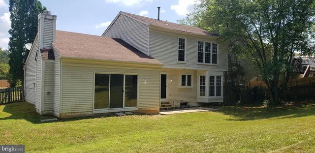 a view of a house with yard and sitting area