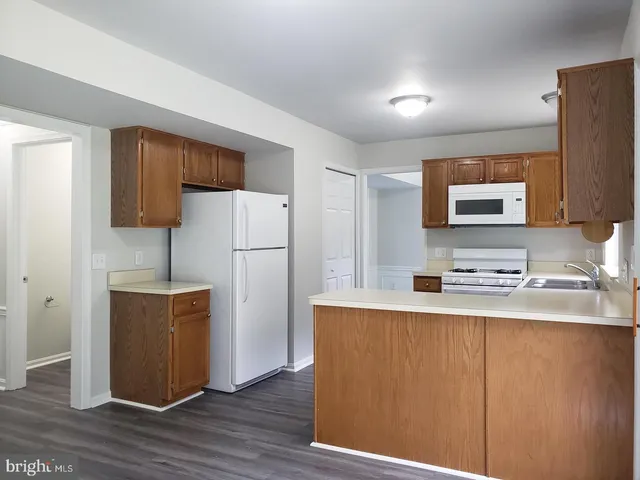 a kitchen with stainless steel appliances a refrigerator and a sink
