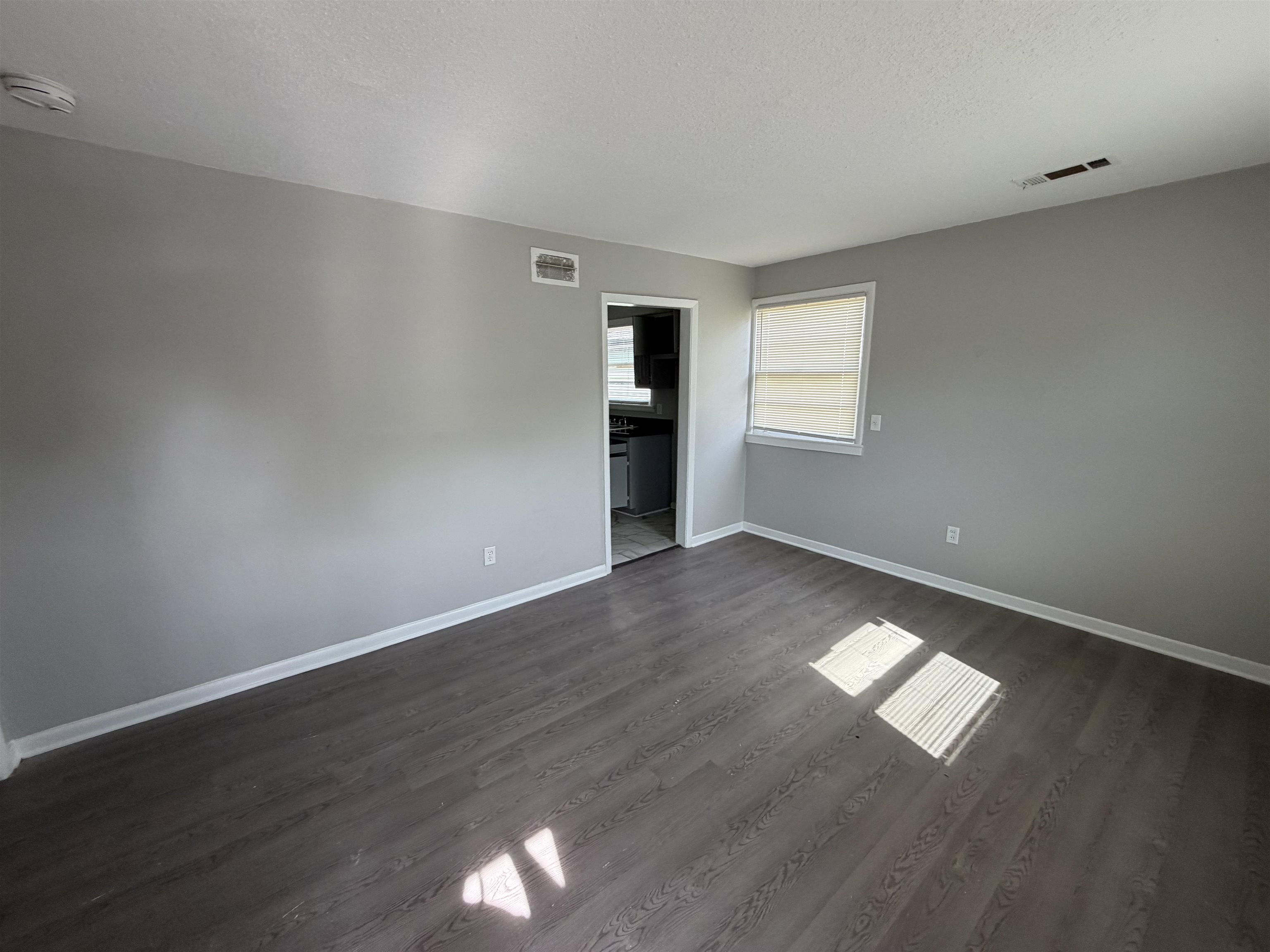 3525 Rochester Road Memphis, TN 38109 - Photo 2 of 10 Spacious interior featuring wood-finish flooring, light gray wall paint, and white trim