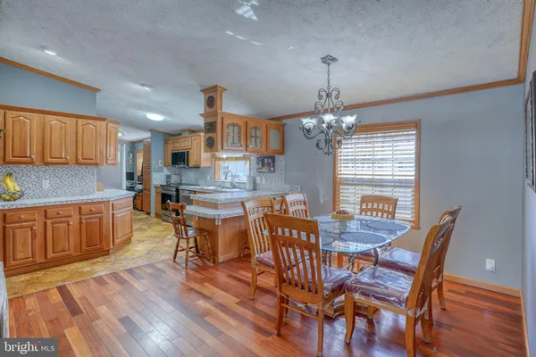 a kitchen with kitchen island granite countertop wooden cabinets and counter space