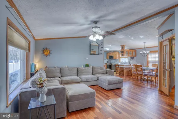 a living room with furniture and a chandelier