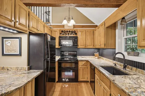 a kitchen with a sink stove and refrigerator