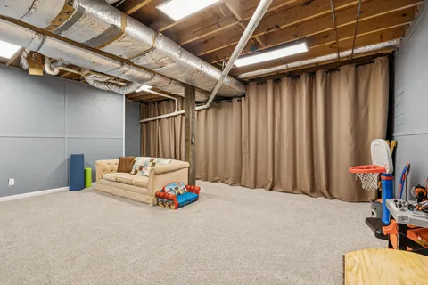 a bed room with a bed and a chair