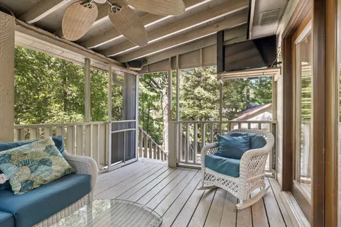 a balcony with furniture and wooden floor