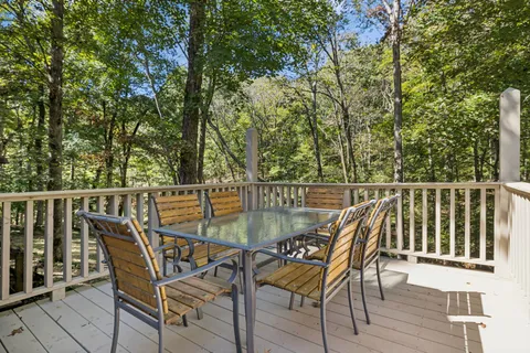 a view of a wooden deck with furniture