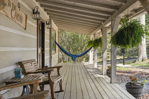 a view of balcony with wooden floor and outdoor seating