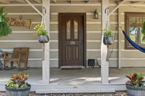 a front view of a house with a potted plant